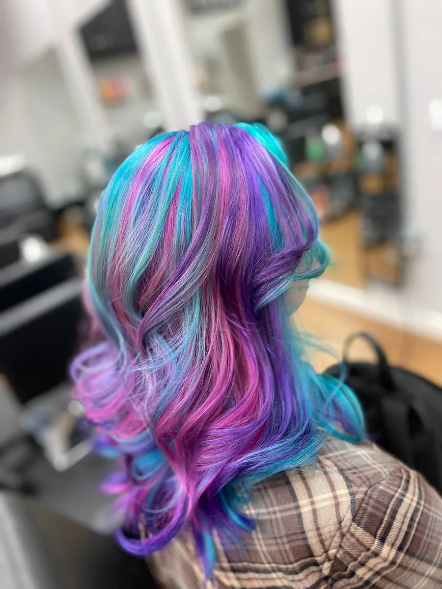Layered hair in purple, pink, and teal vivid color