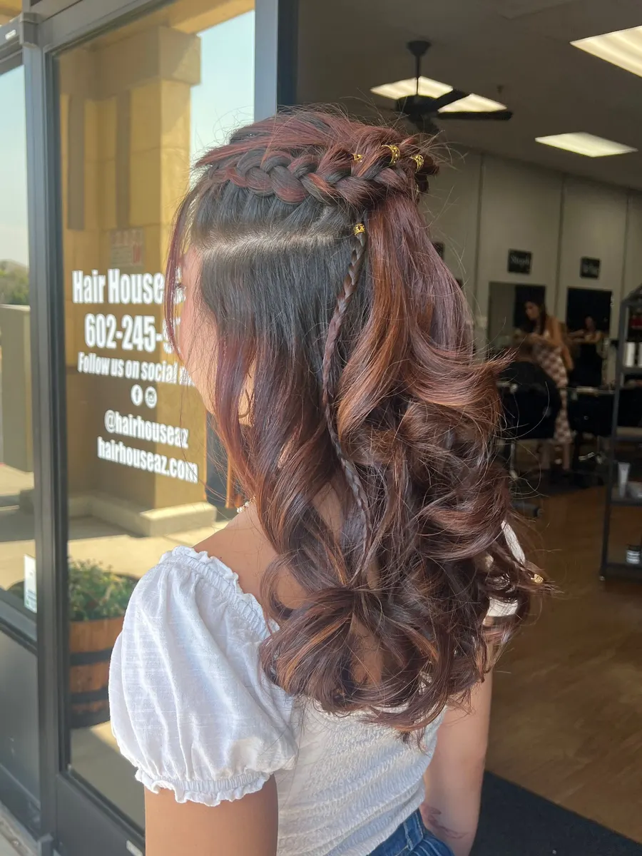 Braided half-up style with long chestnut curls